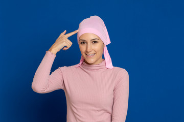 Young woman with pink scarf on the head on a blue background