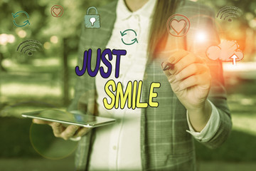 Conceptual hand writing showing Just Smile. Concept meaning assume a facial expression indicating...
