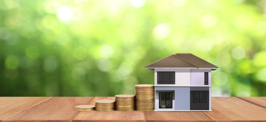 Obraz na płótnie Canvas House Model and coins . Housing Real Estate concept. home business idea