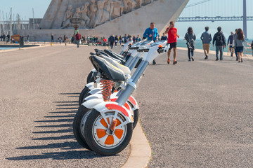 group of modern scooters on the city promenade of Lisbon