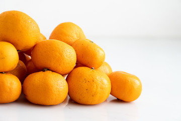 multiple orange on  white marble surface. Concept for fruit nutrition and diet food.