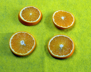  four sliced ​​orange slices lie on a table