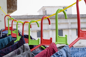 Naklejka premium Shirts hanged in a hanger of color red and green 