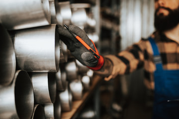 Handsome adult man working in car and truck spare parts warehouse.