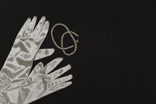 snow-white gloves made of silk and pearls