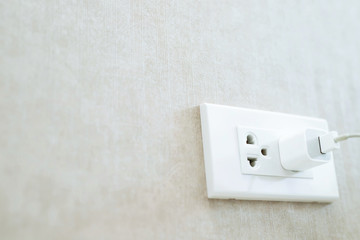 Close Up the electrical power socket and plug socket on wall.