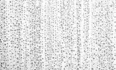 Water drops on a window glass on a winter snowy day
