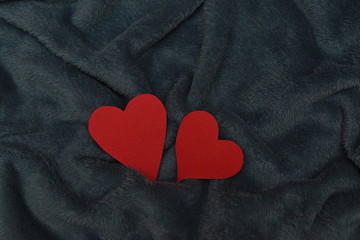Fototapeta premium two paper hearts on a winter wool blanket