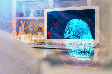 Computer on desktop in office with finger print drawing. Double exposure. Concept of business data security.