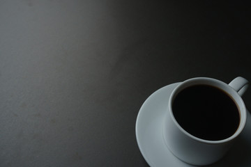 coffee cup on black office desk. fine art. copy space for your text