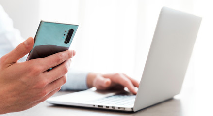 man in office holding phone isolated