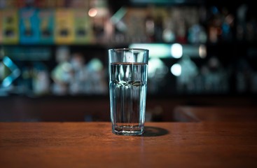 Glass of water placed on wooden table. Close up of glass of water cool ice