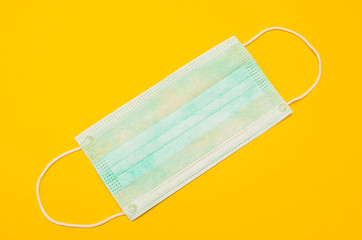Surgical mask on a yellow background. Coronavirus Prevention. Chinese coronavirus outbreak. 