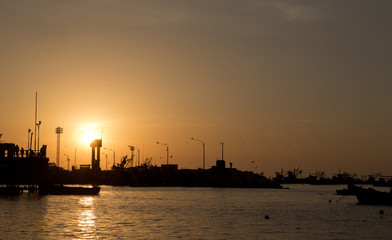 Fototapeta na wymiar Sunset at harbour Illo Peru. Fishingboats