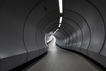 A curve pathway inside underground pedestrian crossing tunnel in Singapore.