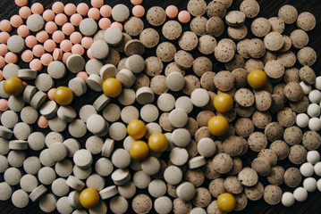 a variety of pills for the treatment of various diseases are scattered on the table
