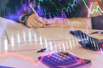Double exposure of man doing analysis of stock market with forex graph.