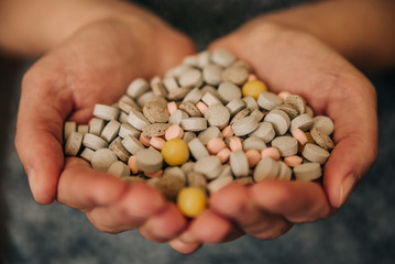a variety of pills for medical needs in the hands