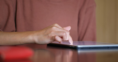 Woman use of tablet on table