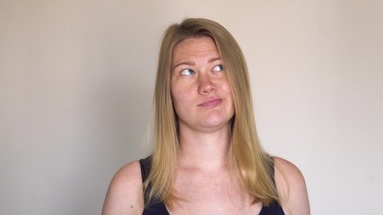 Portrait young attractive woman with freckles look at camera think something.
