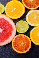 Fresh citrus fruit on black background