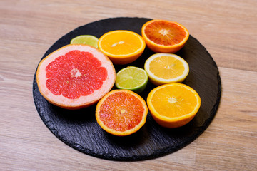 Fresh citrus fruit on black background