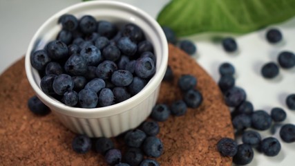 Heap of fresh blueberries in white bowl. Closeup shot. Fresh berry series