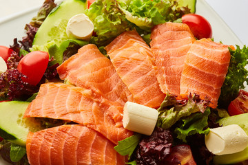 Healthy vegetable salad with smoked salmon. Buddha bowl, dieting concept