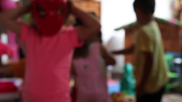 blurry background of kids playing together in an indoor environment