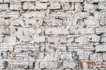 abstract background of an old brick wall painted white close up