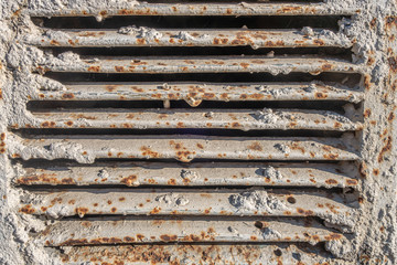 abstract background of an old ventilation grill in spots of rust close up