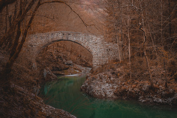 Beautiful stone bridge on Nadige river in enchanted forest