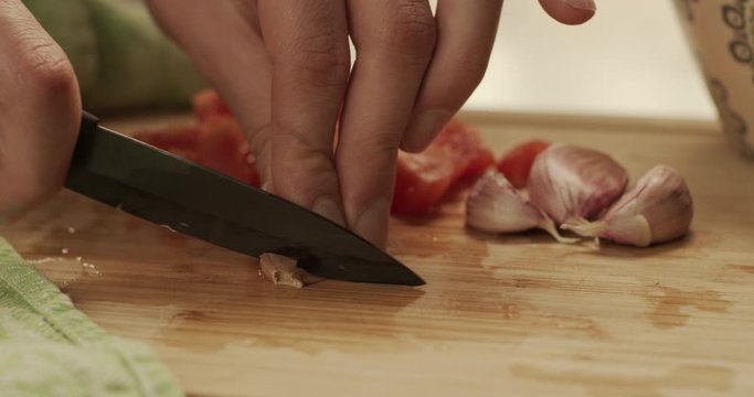 Cutting onion and tomatoes on a chopping board