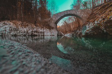 Beautiful stone bridge on Nadige river in enchanted forest