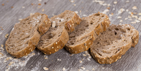fresh slices of rye bread on wooden surface