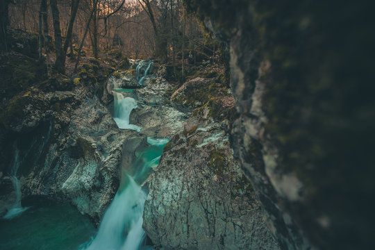 Beautiful water cascades or small waterfall in the valley of Lepena in Slovenian Julian Alps. Emerald green waterfalls in an enchanted forest.