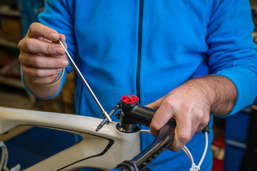 Tightening of a bicycle handlebar stem with the use of a small inbus wrench.