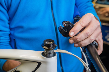 Mechanic servicing a headset on a bicycle.