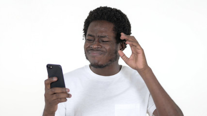 Casual African Man Reacting to Loss and Using Smartphone Isolated on White Background