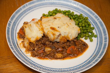 Cottage Pie with peas on a plate