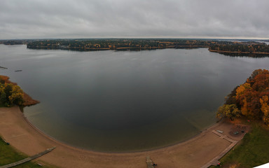 Typical swedish beach or coast close to Stockholm at Hässelby strand, on a cold cloudy autumn day. Drone panorama of a popular beach around Stockholm