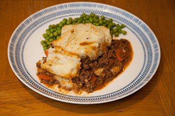 Cottage pie with peas on a plate