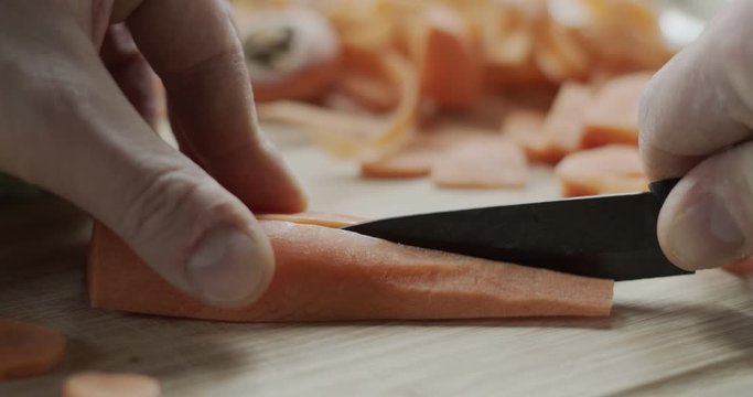 Cutting a carrot on a chopping board