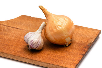 fresh bulb of onion and garlic on a wooden cutting board on a white background