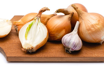 fresh bulbs of onion and garlic on a wooden cutting board on a white background