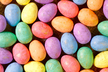 Easter background. Flat lay. Background from bright Easter eggs of different colors. Handmade painted eggs. Close-up, horizontal, cropped shot. Easter concept.