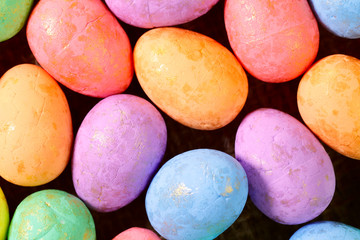 Easter background. Flat lay. Background from bright Easter eggs of different colors. Handmade painted eggs. Close-up, horizontal, cropped shot. Easter concept.