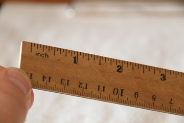 hand holds a wooden ruler