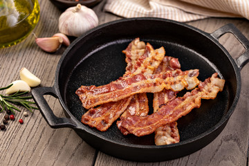 Closeup of slices of crispy hot fried bacon