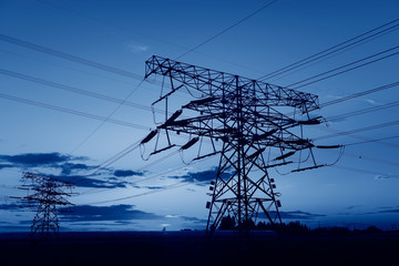 High voltage towers, silhouetted in the setting sun